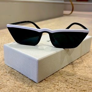 Prada Ultravox Sunnies. Black with white detailing on the rim.
